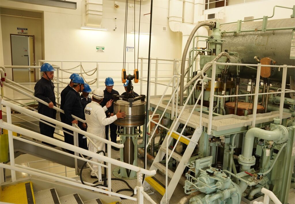 MIS instructors and trainees inside the engine training facility