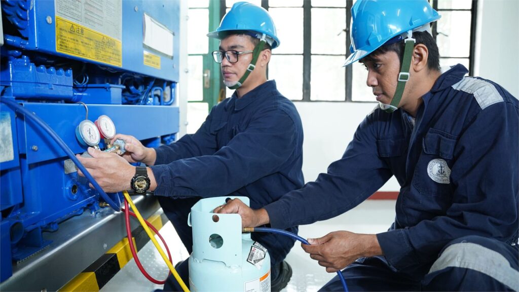 Trainees servicing a marine refrigeration unit