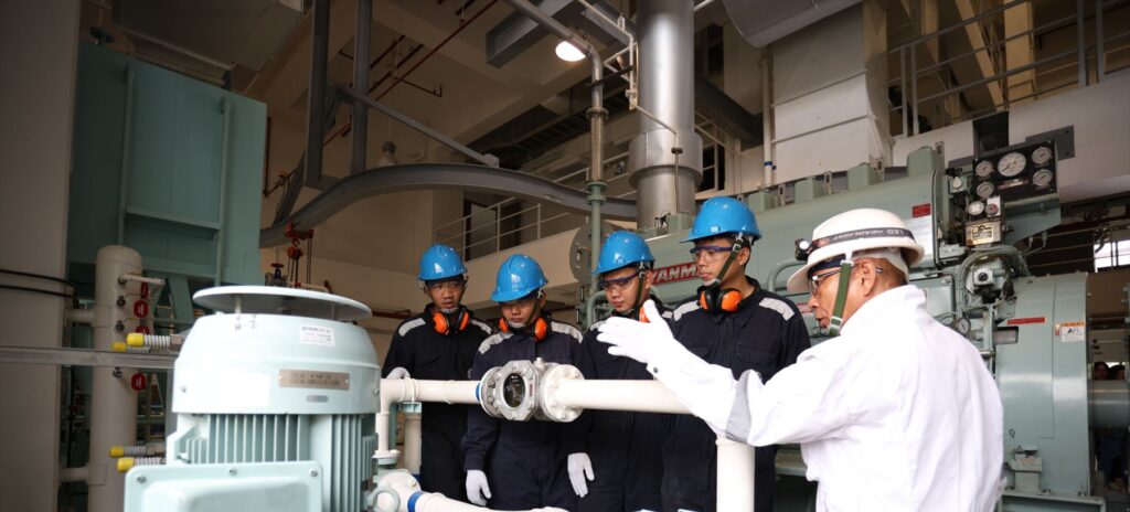 Maritime trainees and instructor in the engine training room