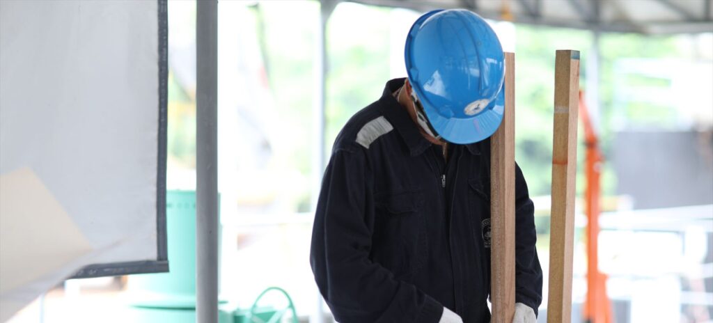 Trainee measuring timber during carpentry training